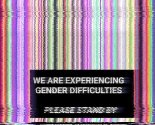 A flickering animated gif of numerous pride flags combined together to look like a glitching television screen. The message reads, 'EXPERIENCING GENDER DIFFICULTIES, PLEASE STAND BY in all caps.'